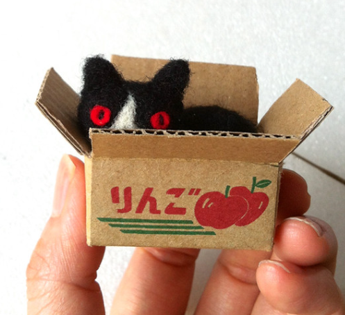 Image of a needle felting cat in a tiny box