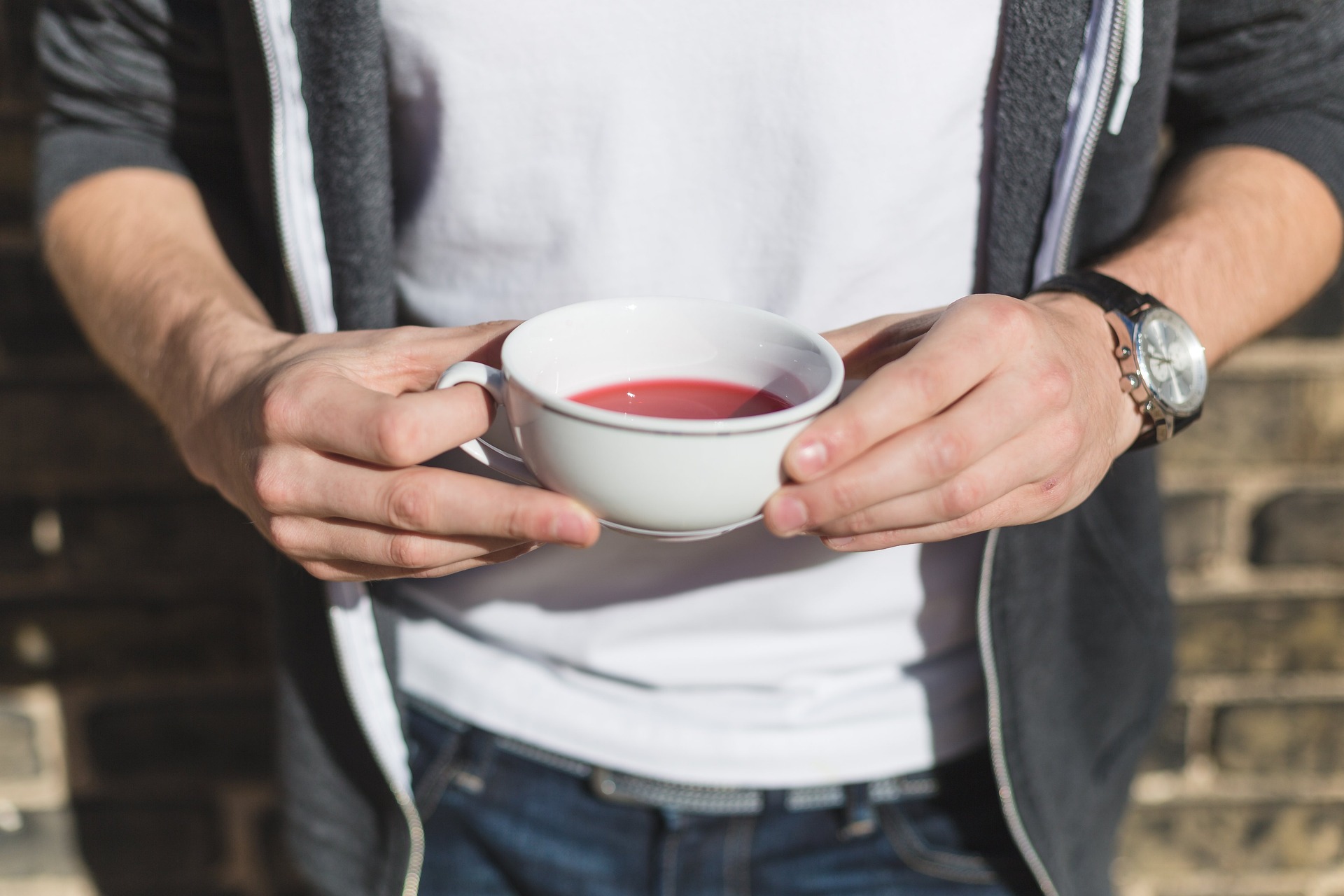 photo of man holding a teacup