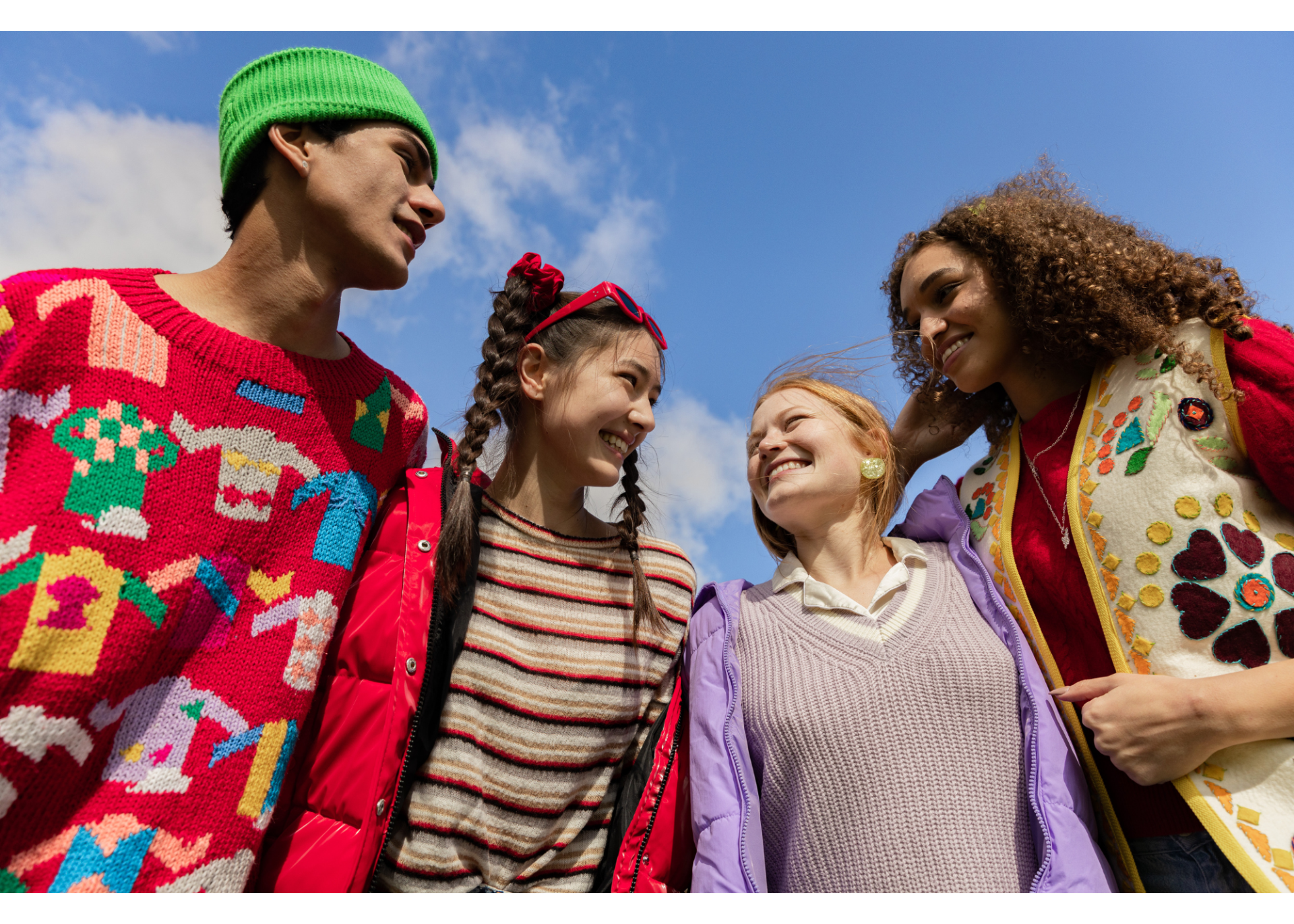 four teens talking and smiling