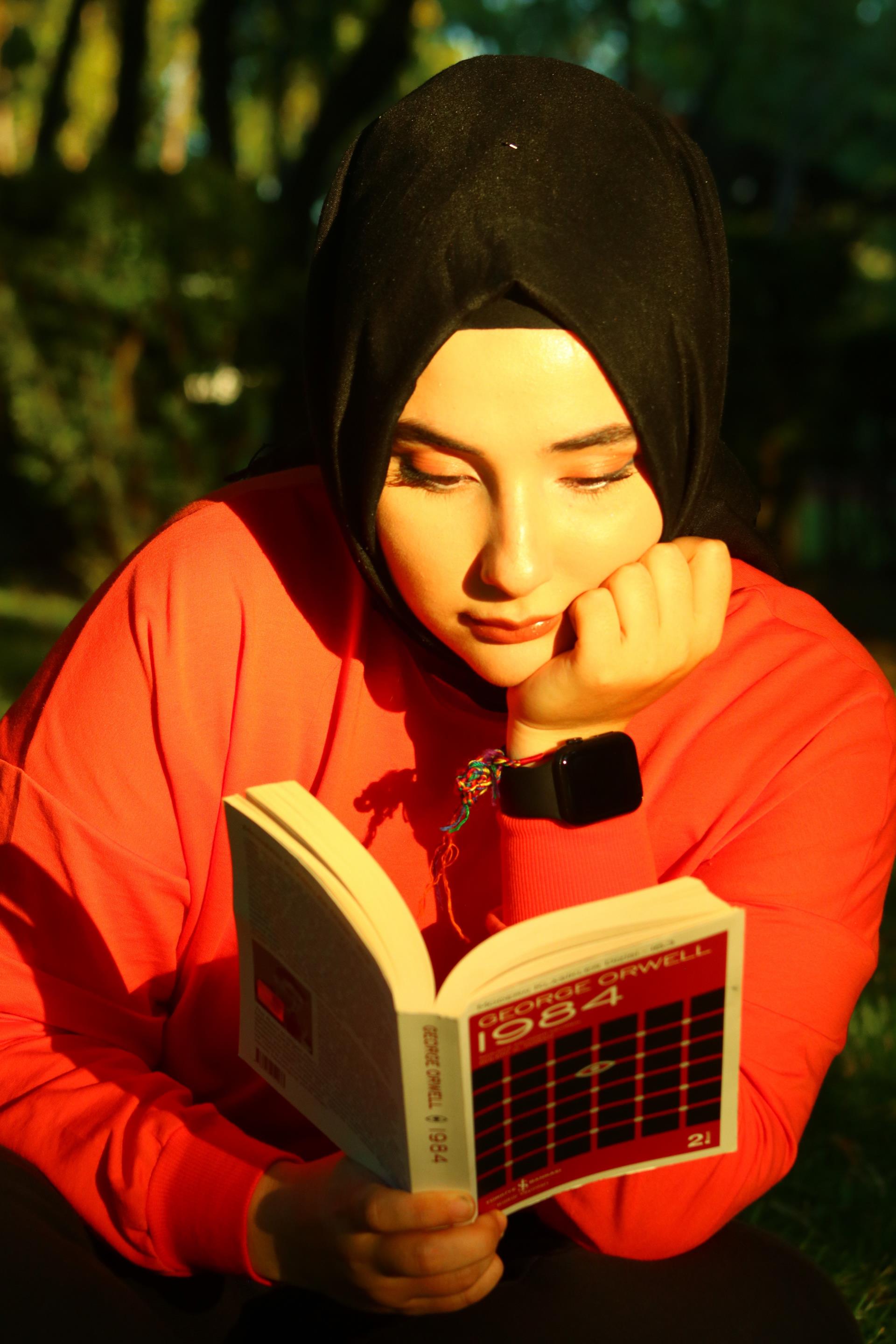 A girl reading a book in the sun